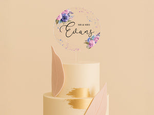 a three tiered wedding cake with a floral topper