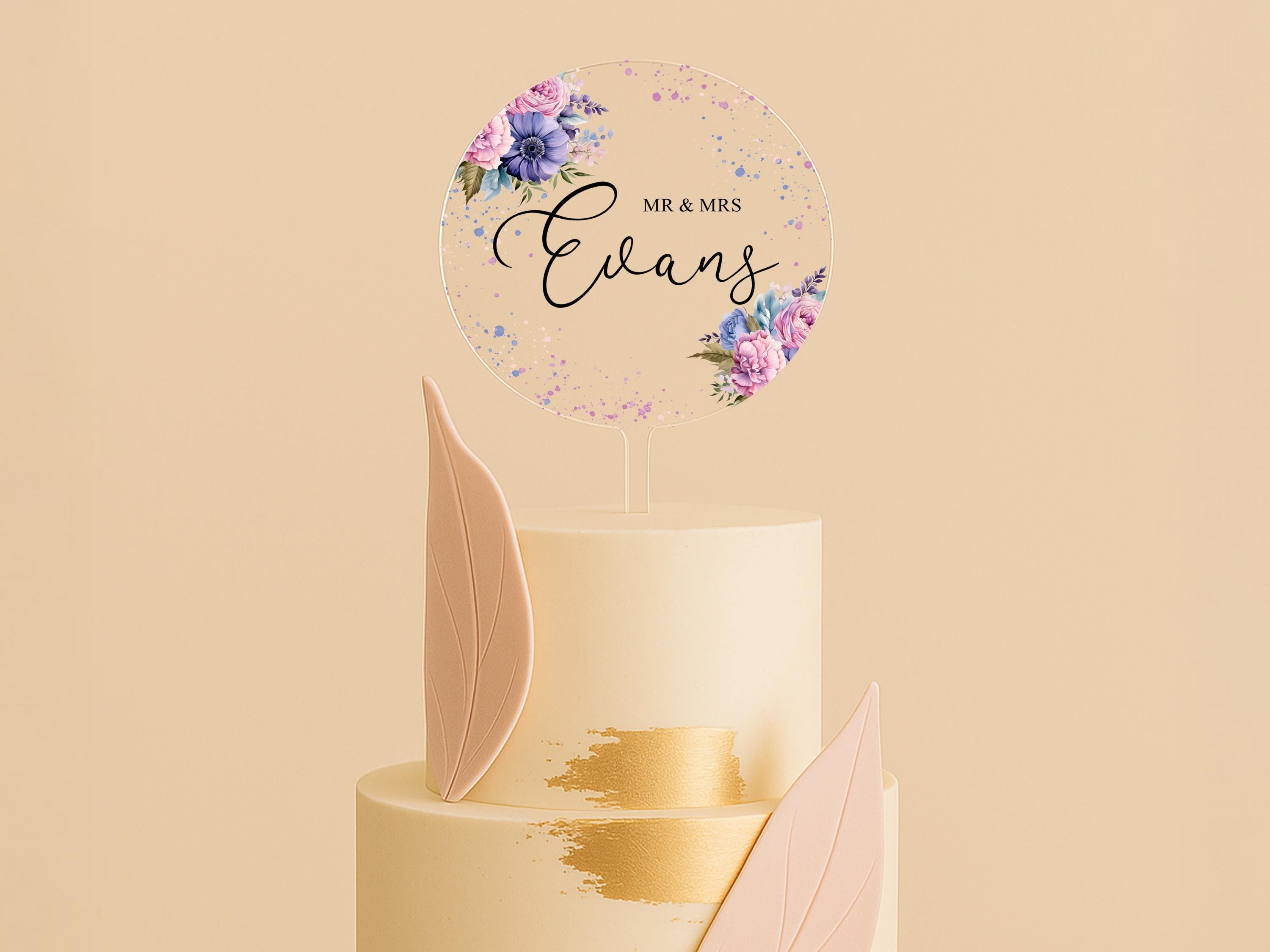 a three tiered wedding cake with a floral topper