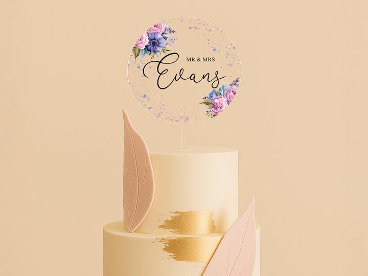 a three tiered wedding cake with a floral topper
