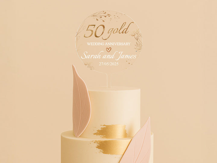 a wedding cake with a gold leaf decoration