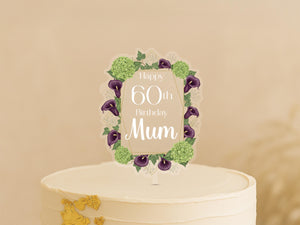 A white cake with a decorative frame and text on it, celebrating a 60th birthday.