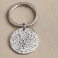 Person holding custom star map keychain showing actual constellation from wedding date