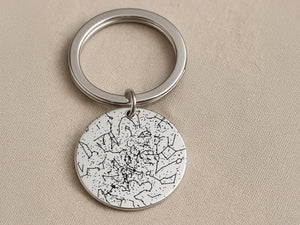 Person holding custom star map keychain showing actual constellation from wedding date