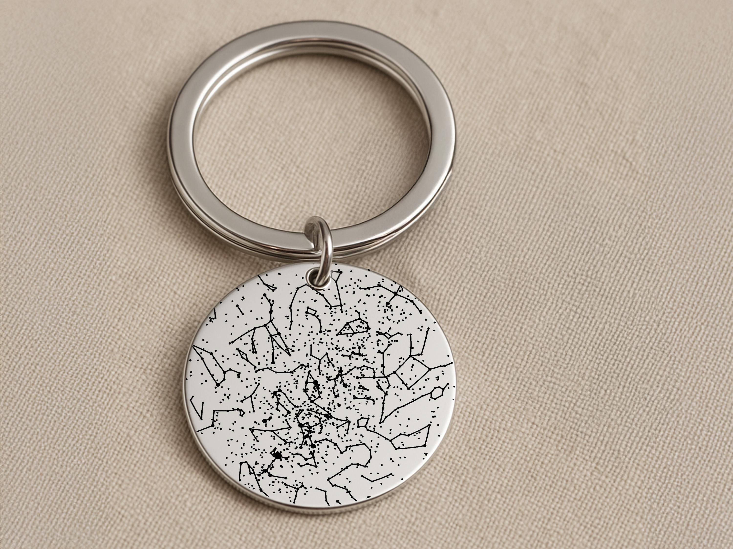 Person holding custom star map keychain showing actual constellation from wedding date