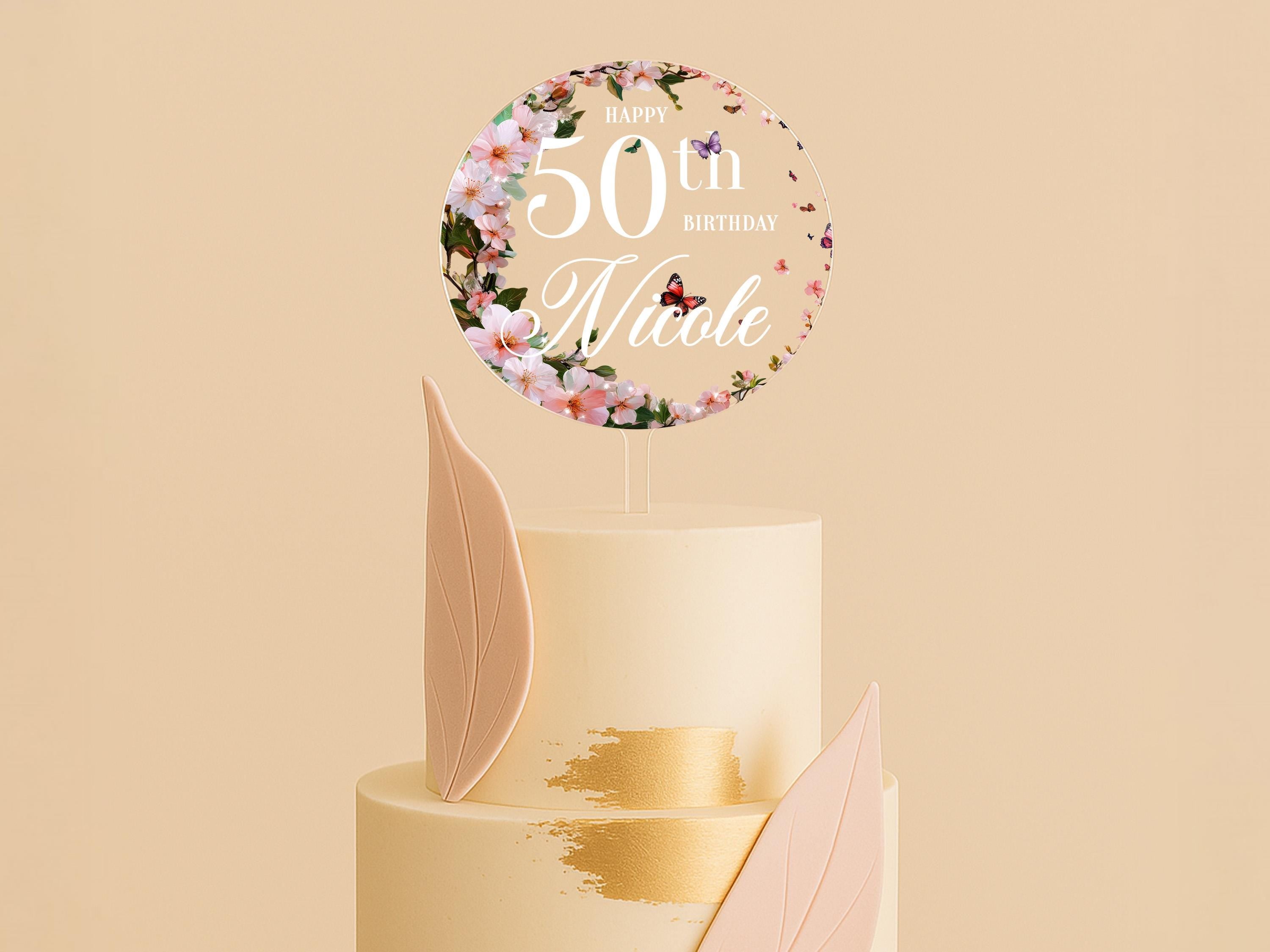 a 50th birthday cake with a floral decoration