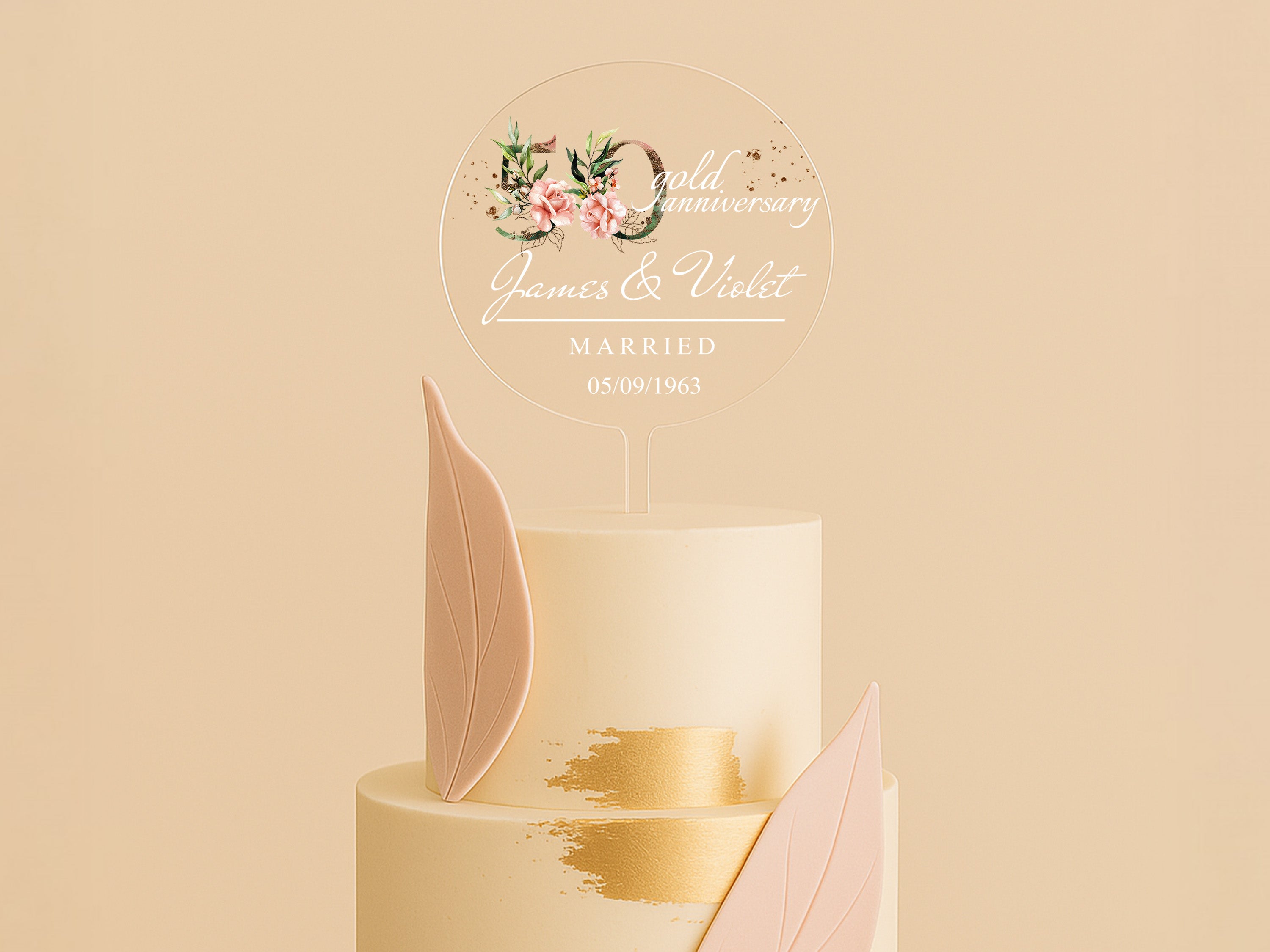 a three tiered wedding cake with pink and gold decorations