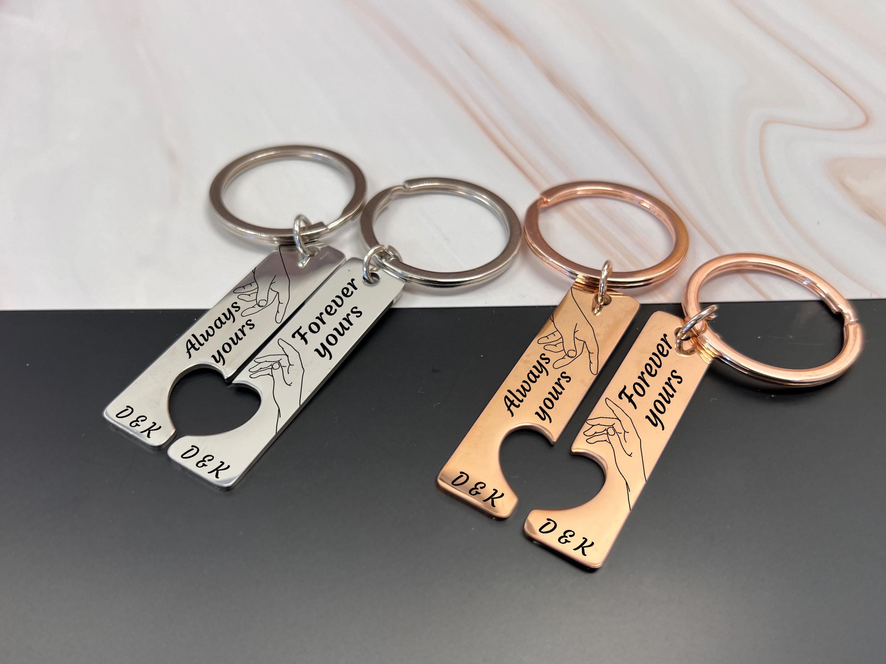 Rose gold custom couple keyrings, engraved with hands touching and personalised names or initials.
