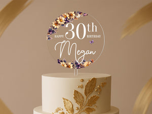 a birthday cake with a white and gold cake topper