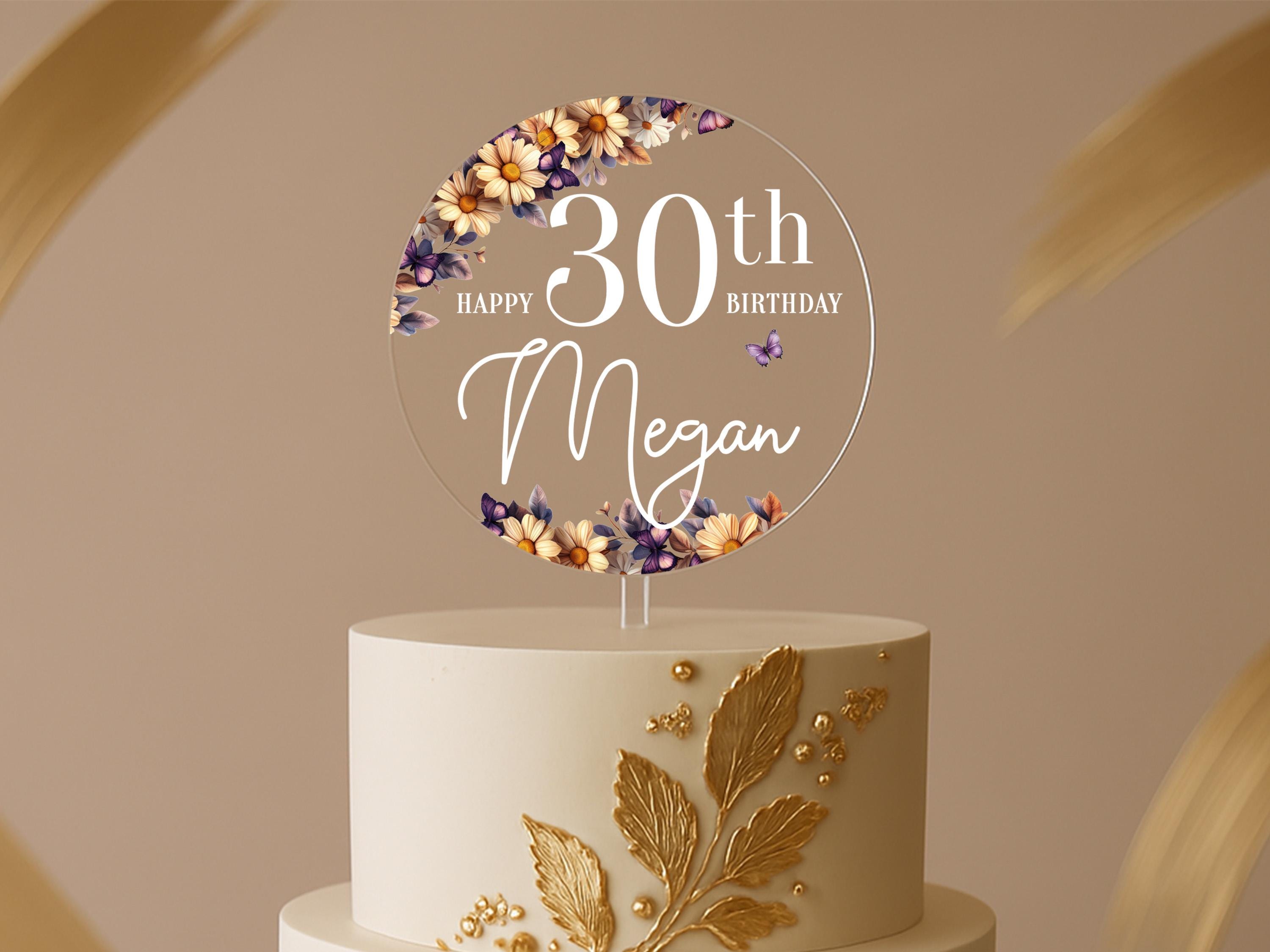 a birthday cake with a white and gold cake topper