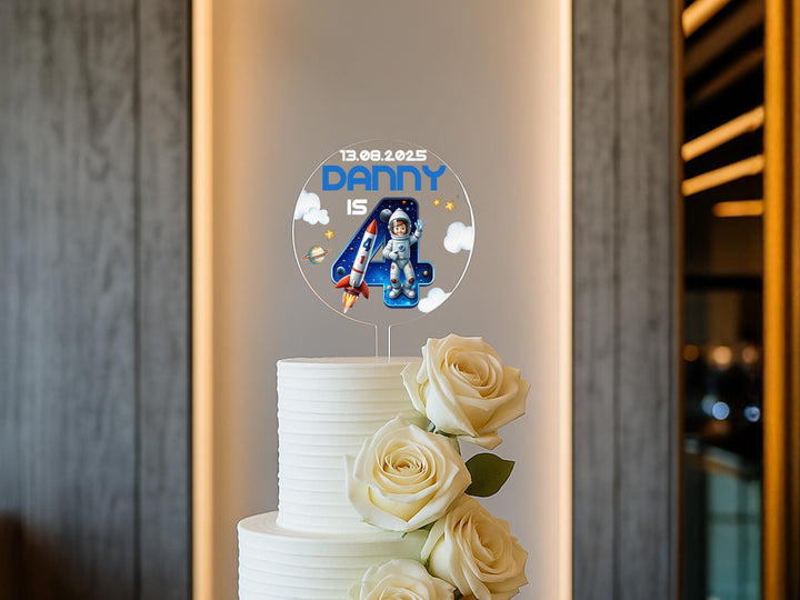 Space themed birthday cake with personalised topper and vibrant illustrations