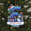 A Christmas ornament with a snowman, presents, and a letter "F" on a tree.