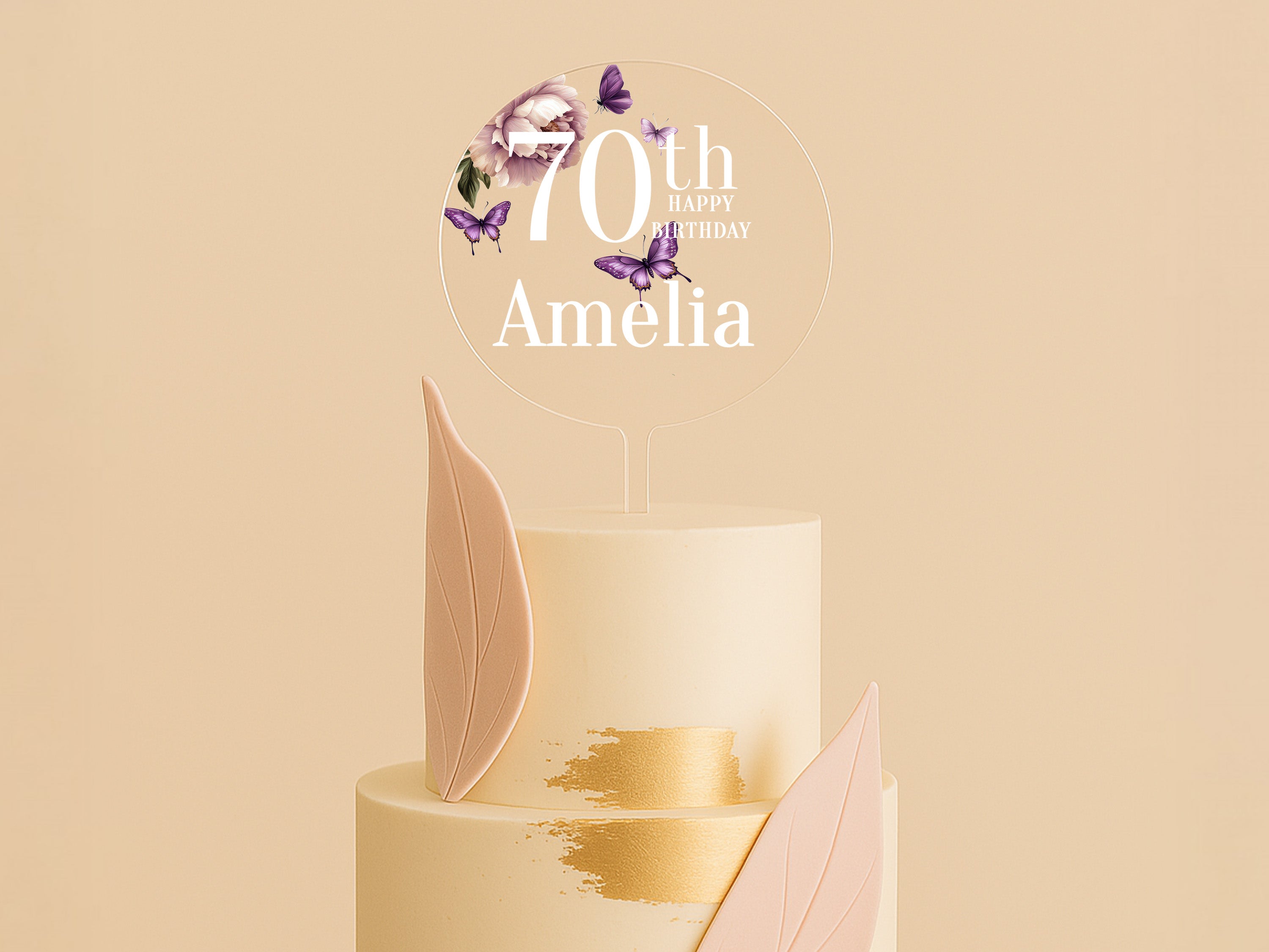 a white cake with pink and gold decorations