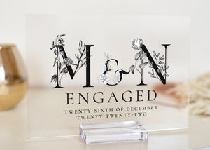 This clear acrylic plaque is available in both A5 and A4 sizes and is the perfect gift for a newly engaged couple. The plaque features black and white letters with the monogram of the first letter for the couple's names.