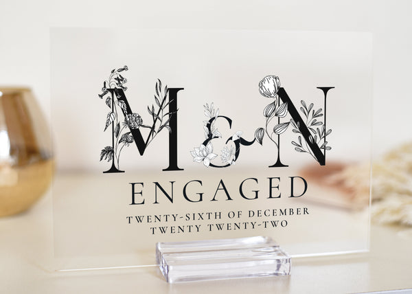 This clear acrylic plaque is available in both A5 and A4 sizes and is the perfect gift for a newly engaged couple. The plaque features black and white letters with the monogram of the first letter for the couple&#39;s names.