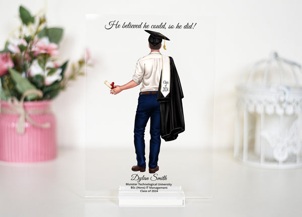 An elegant acrylic graduation plaque and stand, personalized for a 2023 male graduate, showcasing a graduation cap and gown, making it a special gift for a son or any young man celebrating this significant milestone in his life.